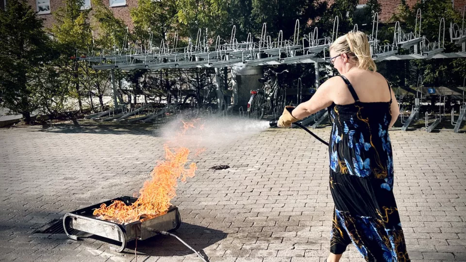 Woman extinguishing a fire