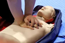 Hands doing CPR and First Aid on a doll.